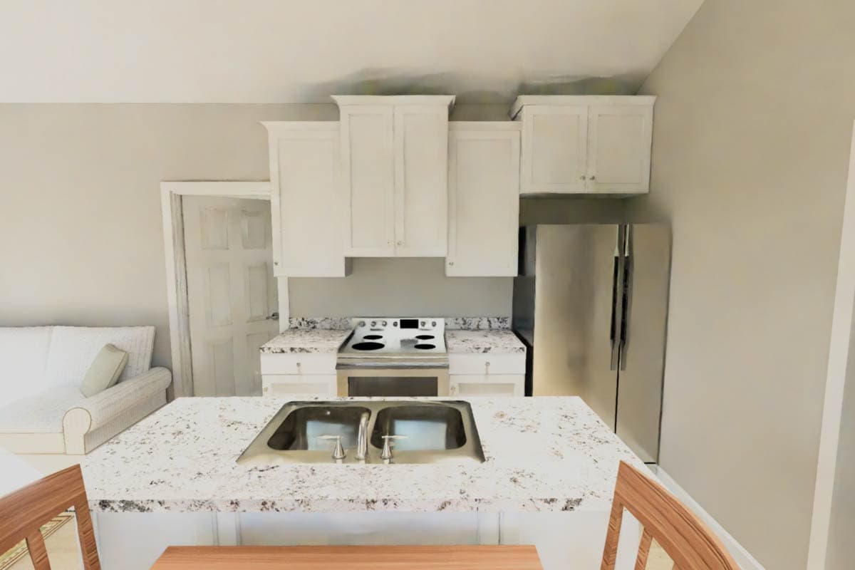 Kitchen with white cabinets, granite countertops, stainless steel refrigerator, stove, and a sink island.