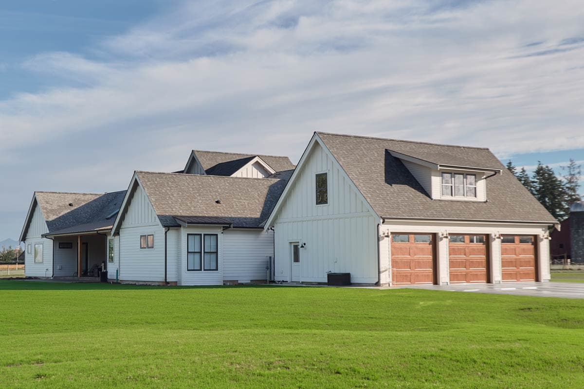 Modern Farmhouse house plan exterior with board and batten siding, gabled rooflines, and a three-car garage.