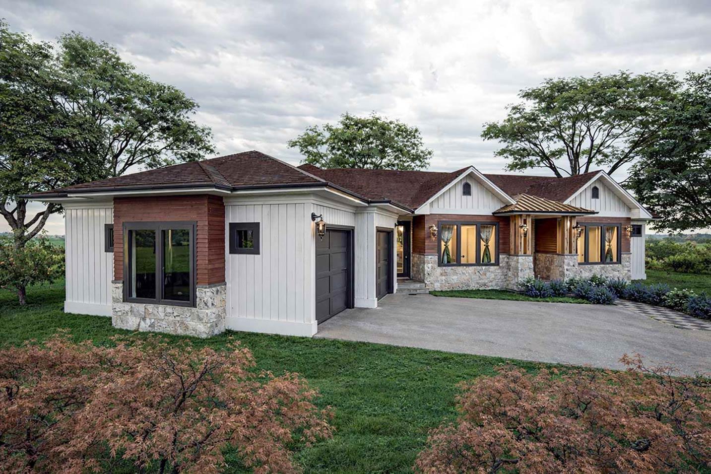House plan exterior with Modern Farmhouse style, two stories, stone and wood siding, gabled dormers, and a two-car garage.