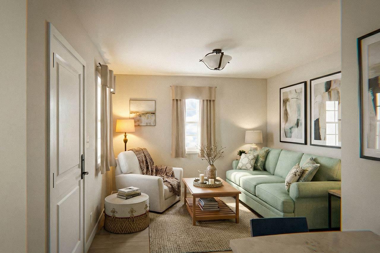 Living room with sofa, armchair, coffee table, and decorative artwork above the sofa. Doors and windows are visible.