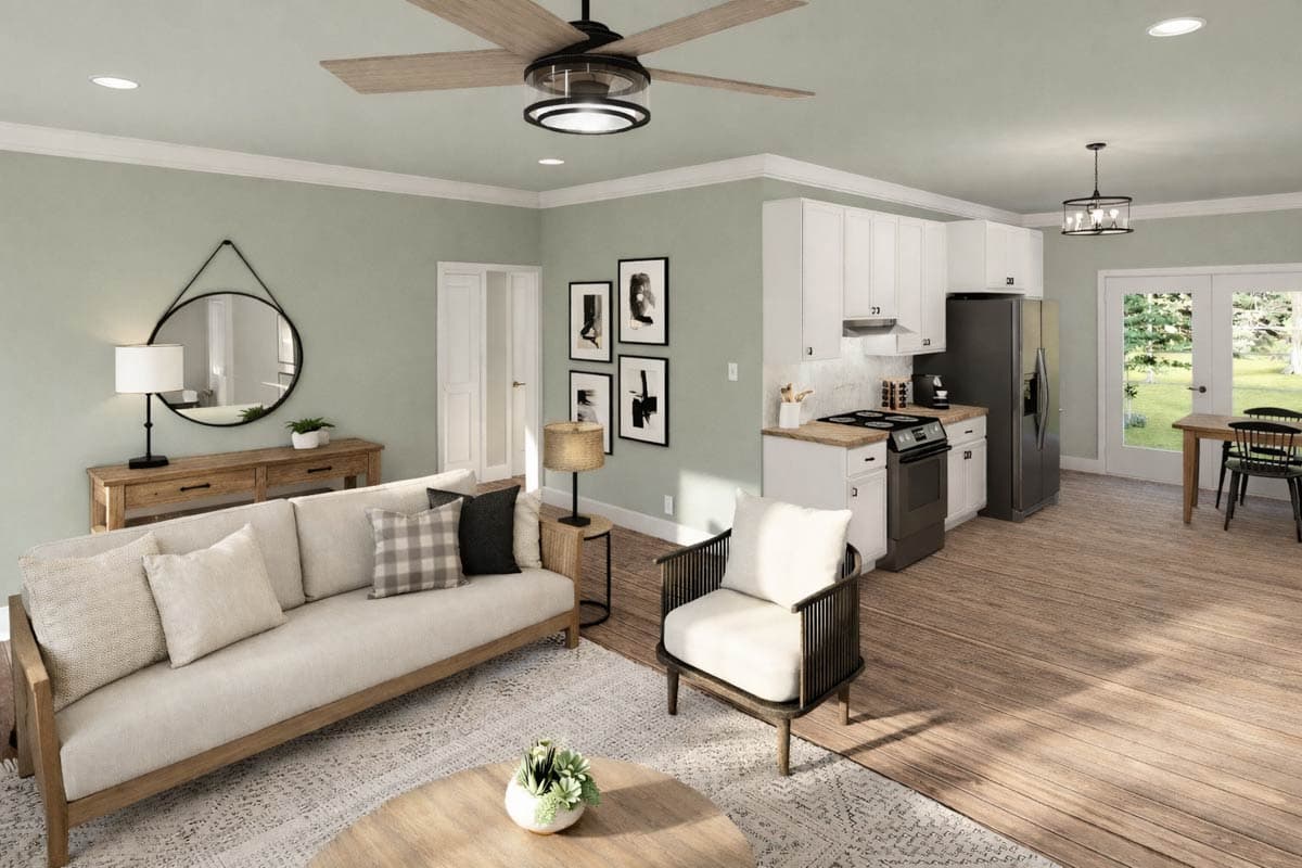 Living room and kitchen with light green walls, sectional sofa, island counter, stovetop, refrigerator, and dining table.