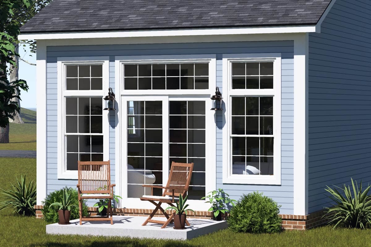 House plan exterior featuring a light blue siding, white trim, dual pane windows, and a central French door.