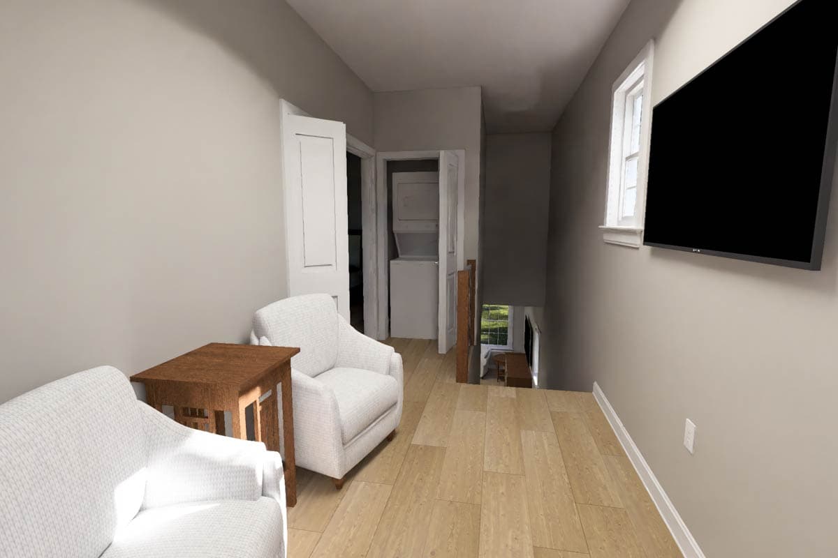 Interior view of a hallway with two chairs, a table, stackable washer/dryer, and a television mounted on the wall.