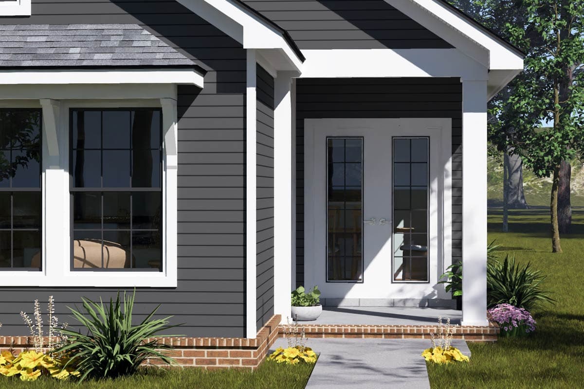 House plan exterior: Dark gray horizontal siding, white trim, double glass doors, and multi-pane windows.