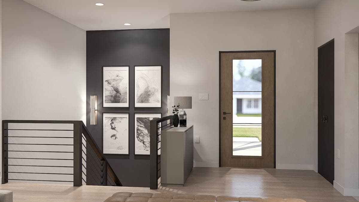 Interior view of a modern home entrance with a wood-framed door, abstract art, and a horizontal slatted railing.