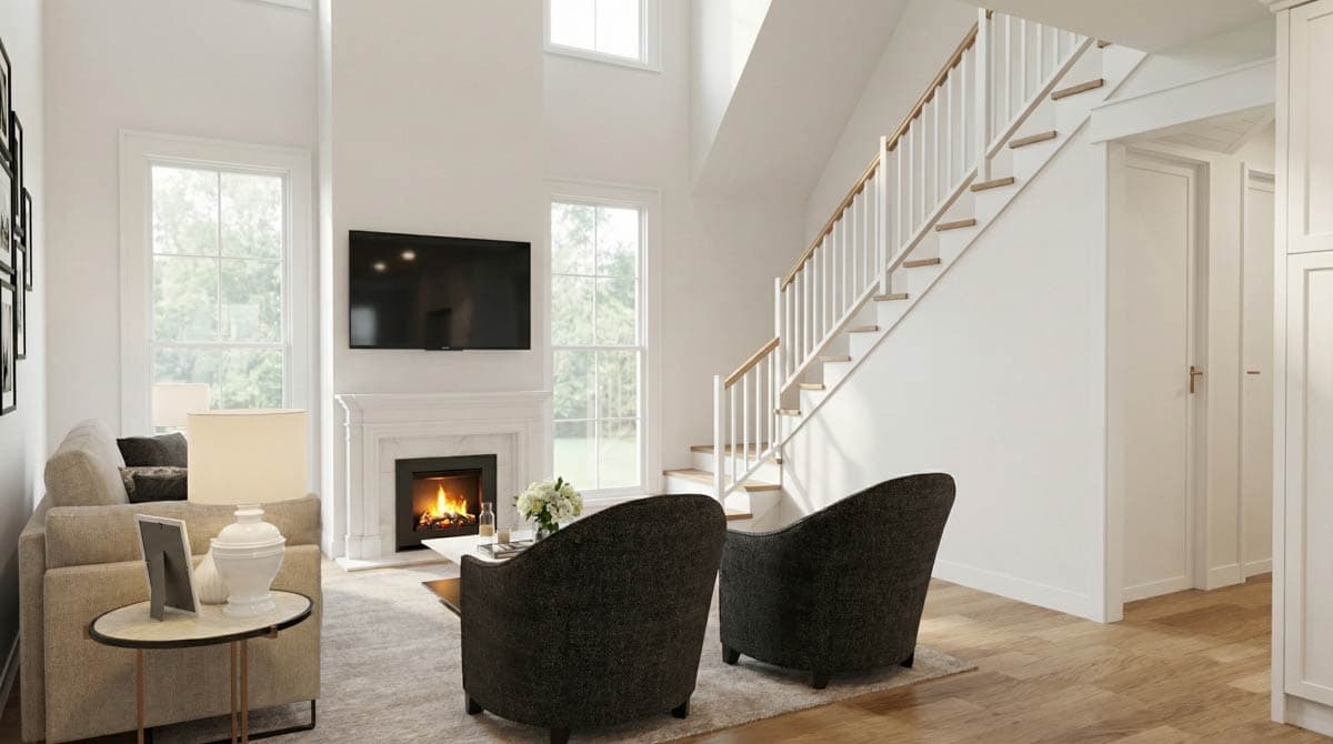 Living room with two-story ceiling, fireplace, television, staircase, and large windows.