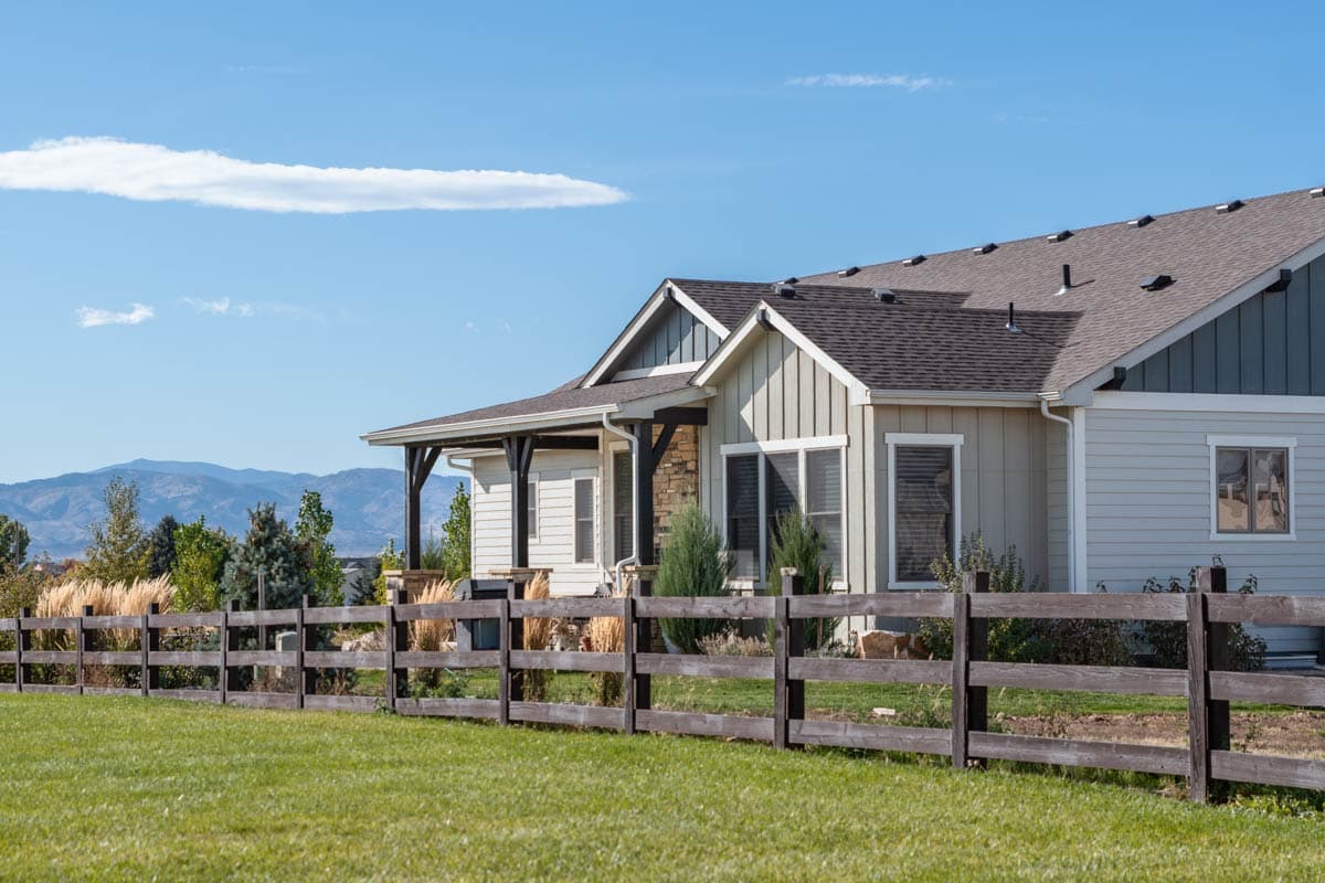 Modern Farmhouse house plan exterior with covered porch, gable rooflines, and stone accents.