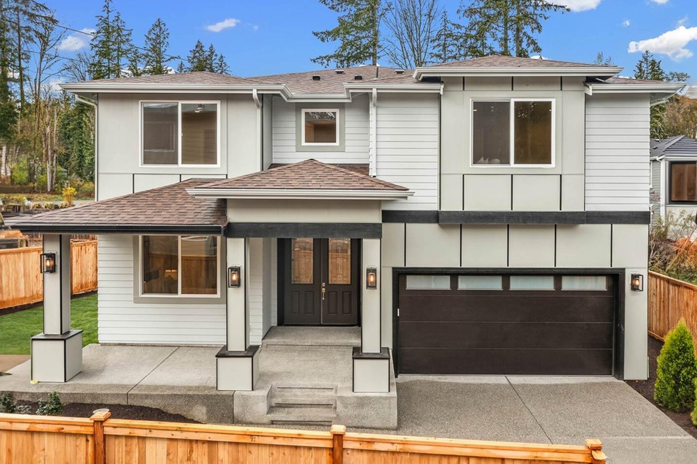 House plan exterior: Two-story modern home with covered entry, gabled roof, double front doors, and attached two-car garage.