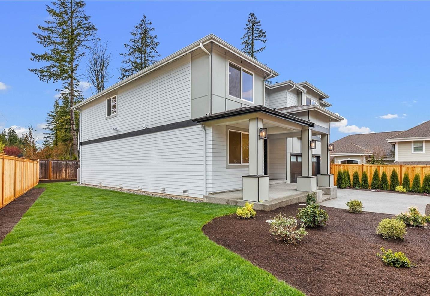 Modern two-story house plan exterior with horizontal siding, covered entry porch with square columns, and attached garage.
