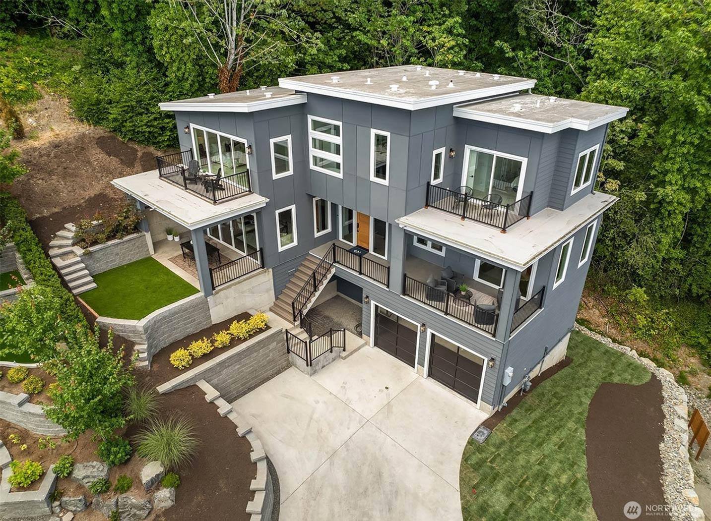 Modern house plan exterior with multiple balconies, flat roofs, large windows, and a three-car garage.