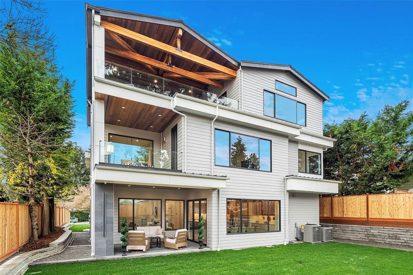 House plan exterior: contemporary multi-story home with exposed wooden beams, multiple balconies, and extensive windows.