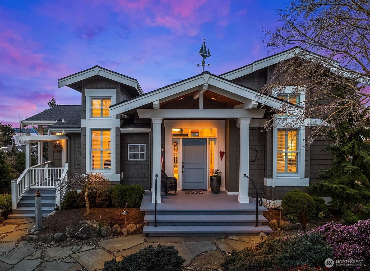 Craftsman style house exterior with a covered porch, stacked gables, and a prominent entryway.
