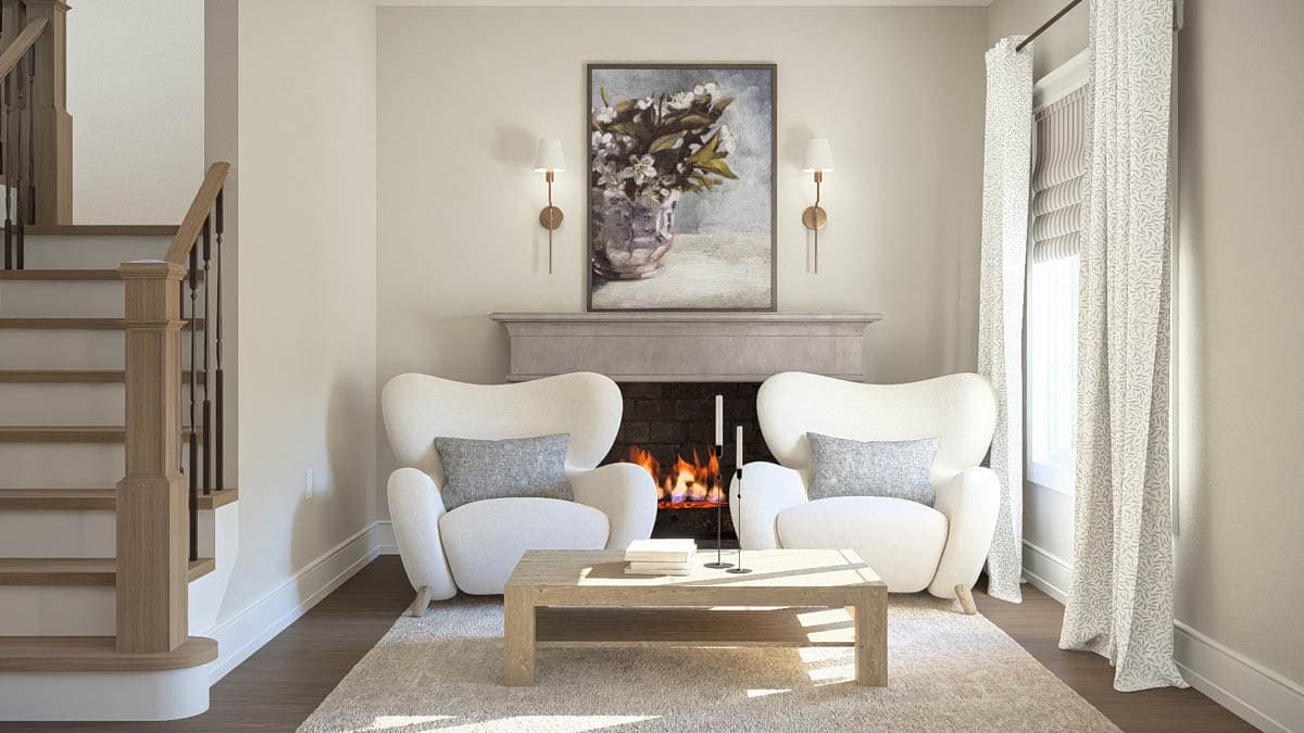 Living room with fireplace, two chairs, coffee table, and wood staircase.