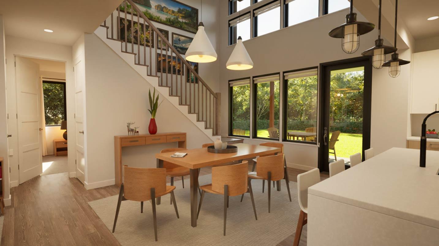 Dining area and open staircase with wood treads and railing, overlooking large windows to a backyard.