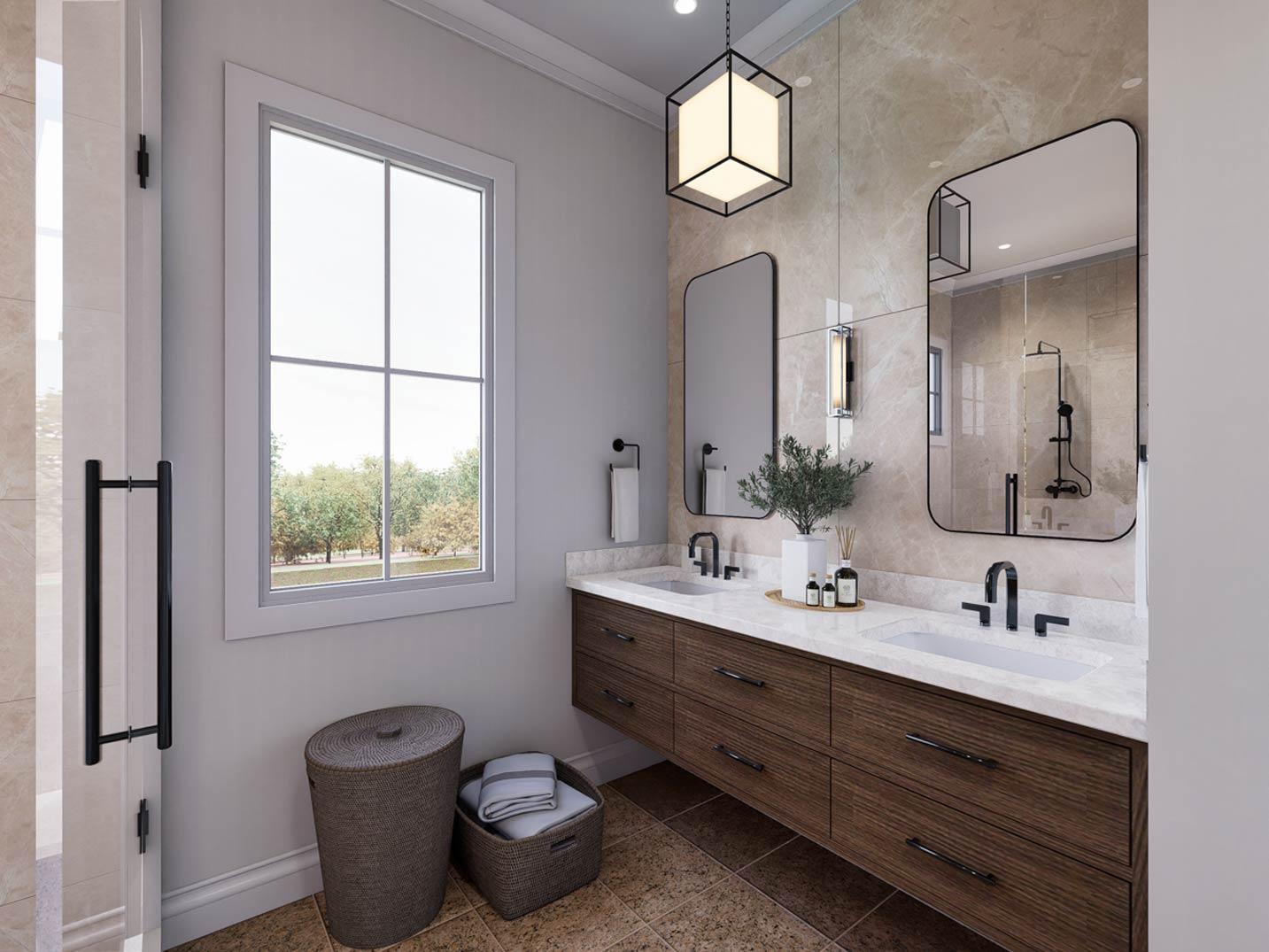 Bathroom with double vanity, modern pendant light, and large window with view of trees.