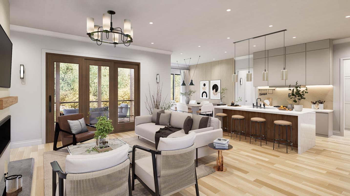 Open-concept living area with sectional sofa, fireplace, dining area, and kitchen island with bar seating.