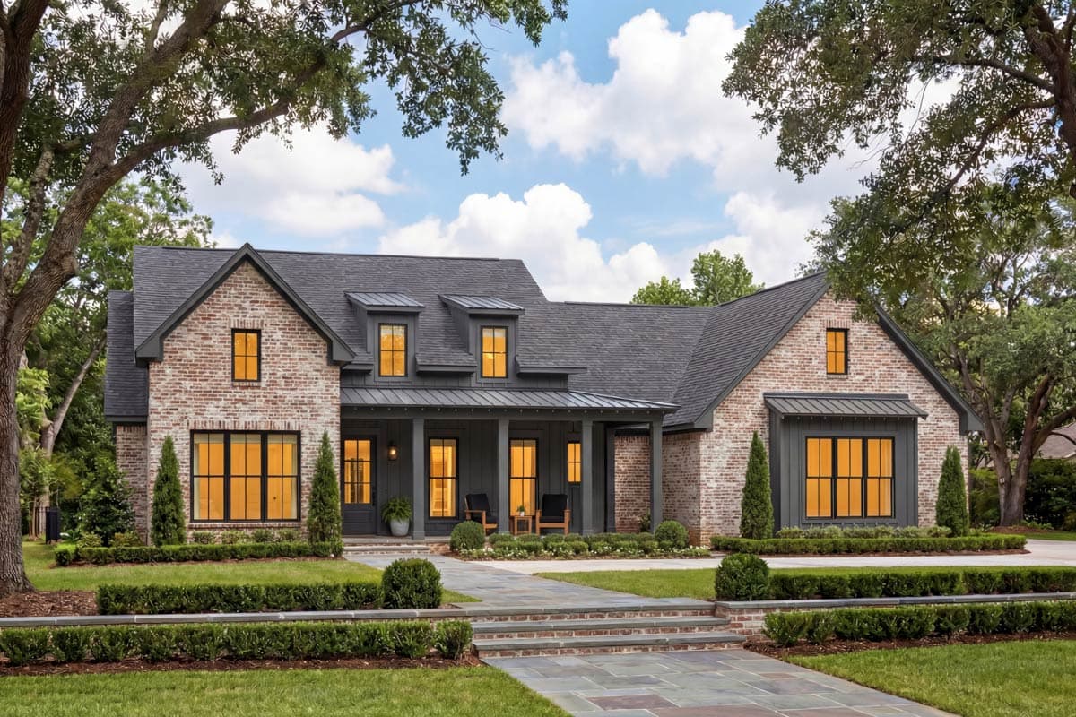 House plan exterior with brick facade, gabled dormers, covered porch with columns, and metal roof accents. Modern farmhouse style.