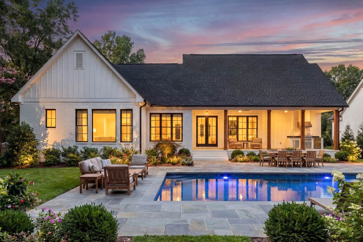 Modern Farmhouse style house plan exterior with white brick, gable roof, covered porch, and outdoor kitchen.