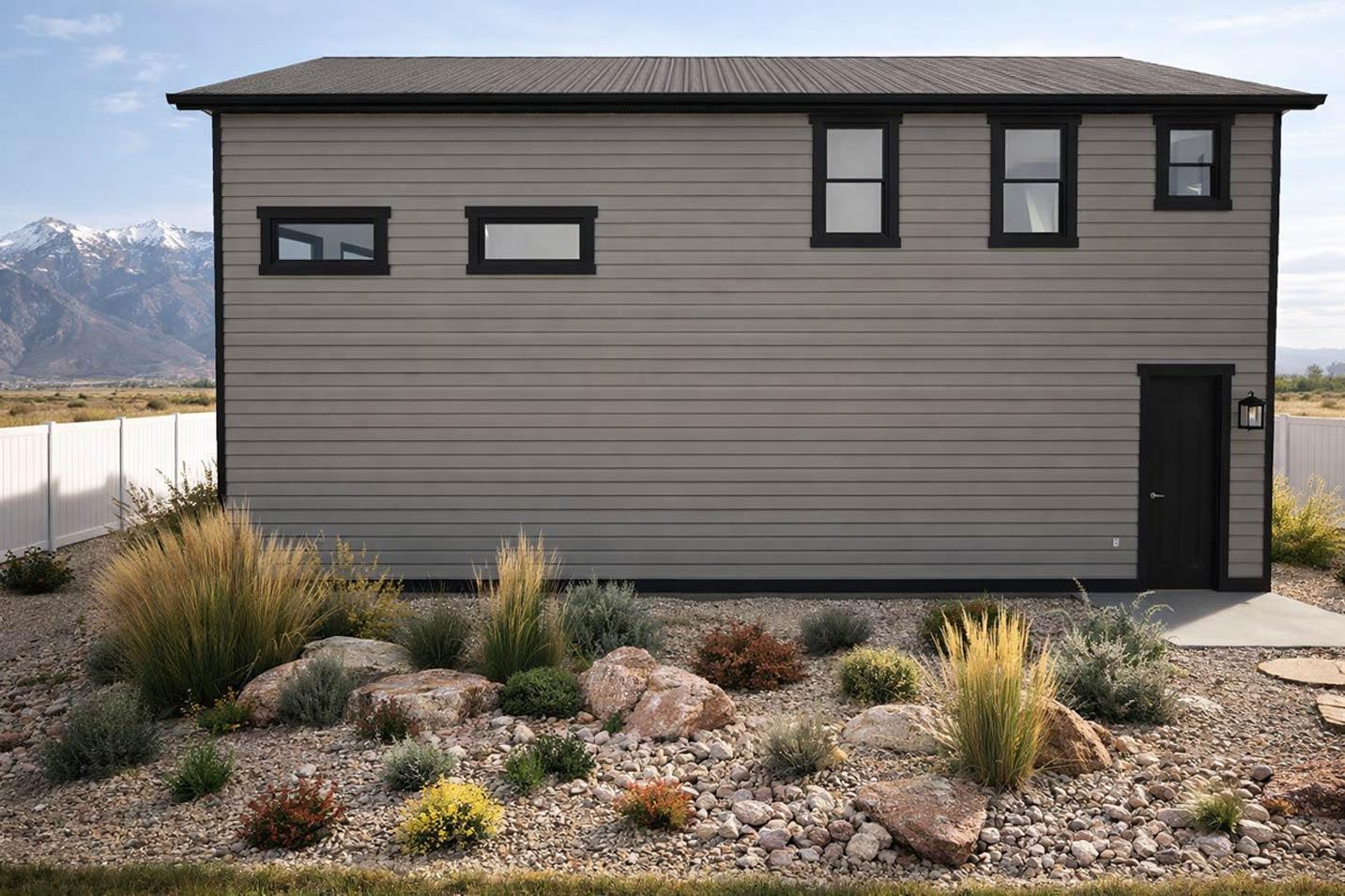 House plan exterior with horizontal siding, a metal roof, one door, and varied window sizes on two levels.
