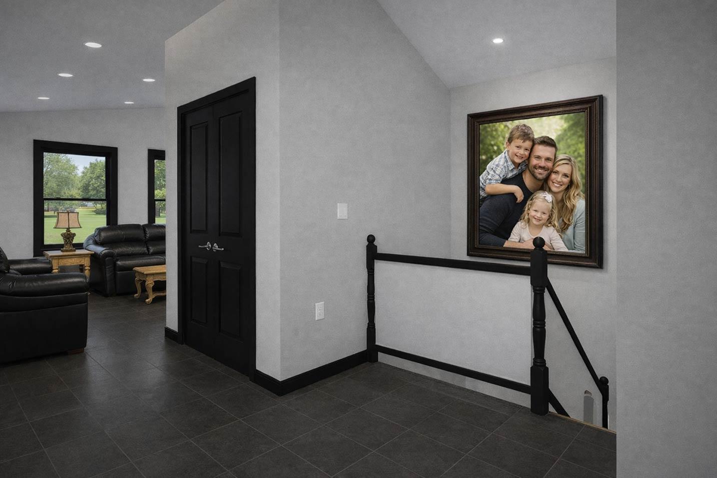 Interior view of a hallway with black double doors, dark tile floor, and a framed family portrait above a staircase with black railing.
