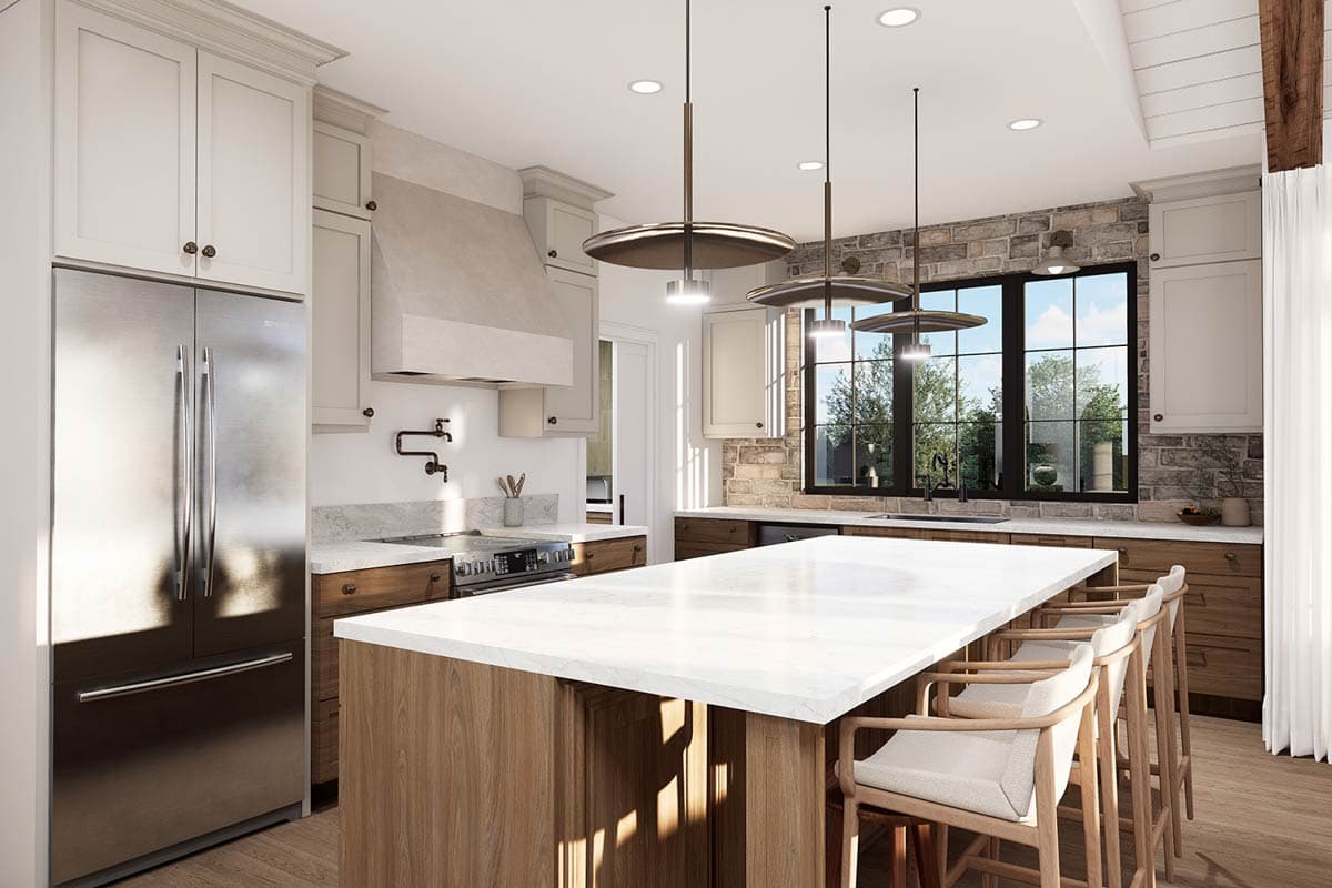 Kitchen with large island, stone backsplash, stainless steel refrigerator, and pendant lighting.