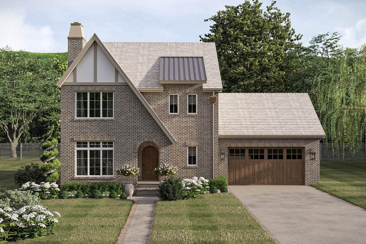House plan exterior: Two-story brick home with prominent gable, arched entry, and attached two-car garage.