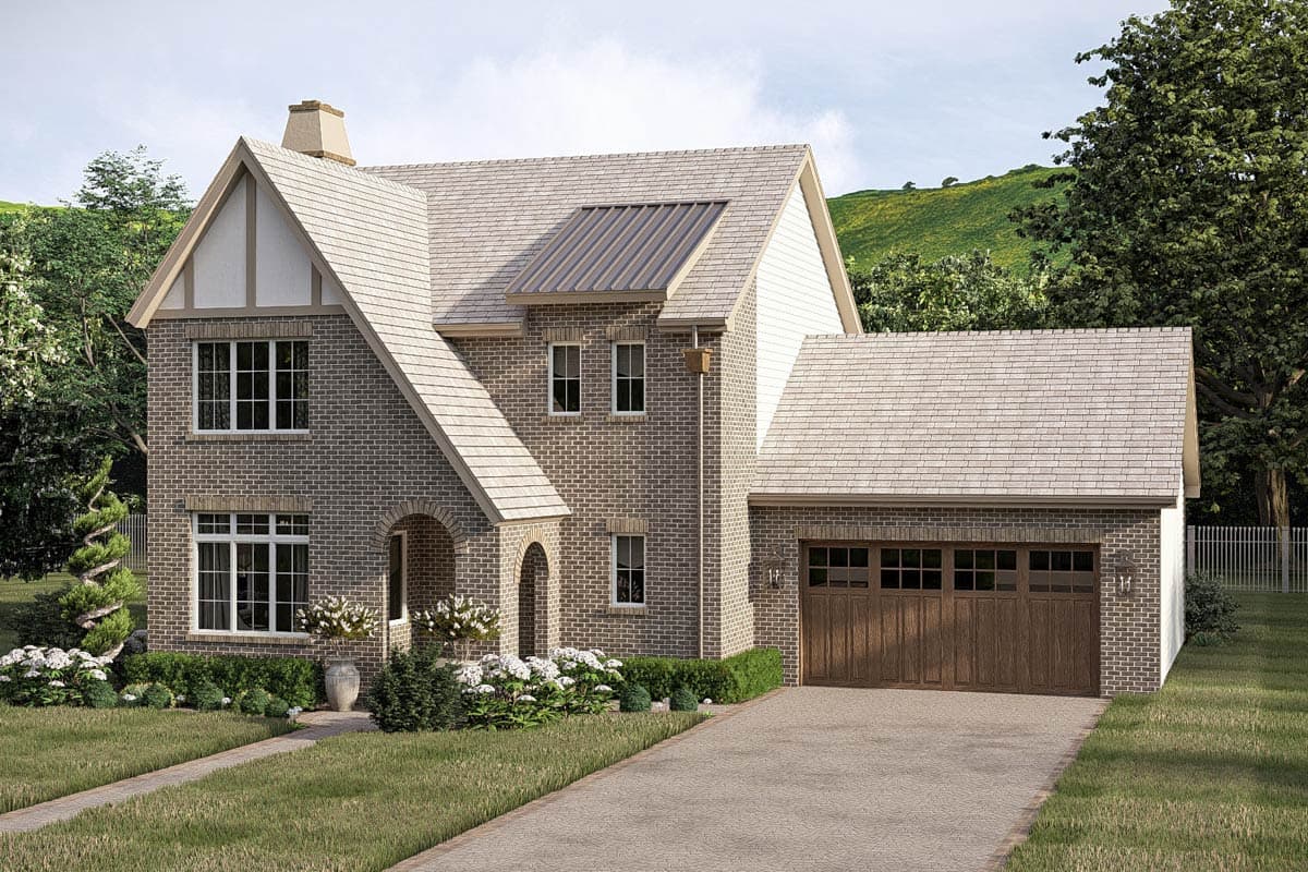 House plan exterior: Two-story brick home with steeply pitched gables, prominent dormer, arched entry, and attached two-car garage.