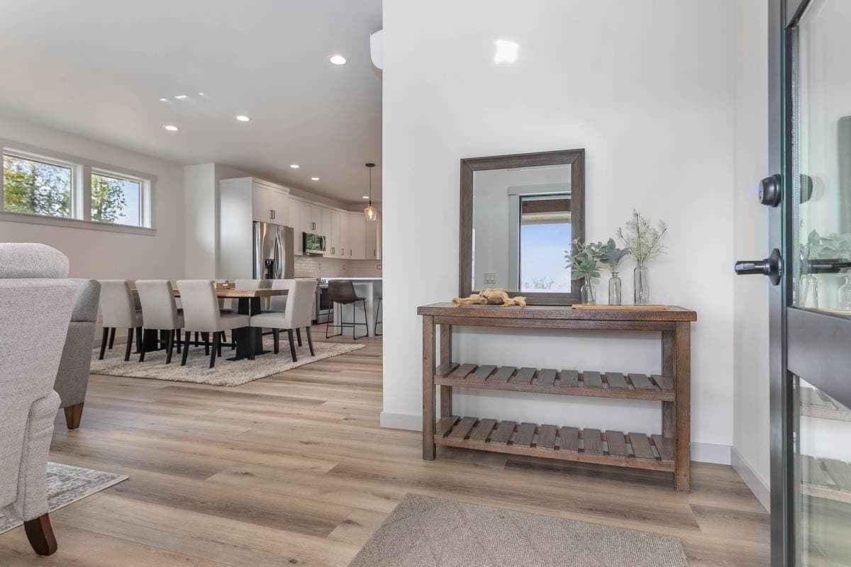 Open concept interior view with dining area, kitchen with island, and entryway console table.