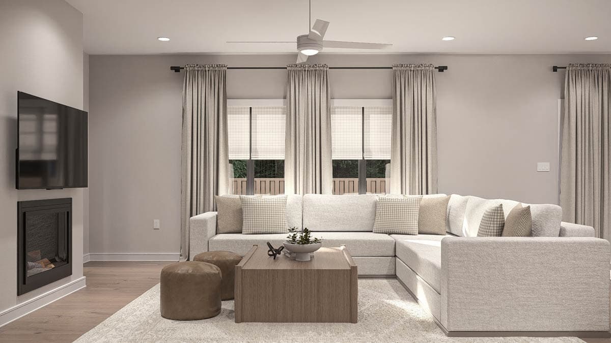 Great room interior rendering with a sectional sofa, fireplace, large windows, and ceiling fan.