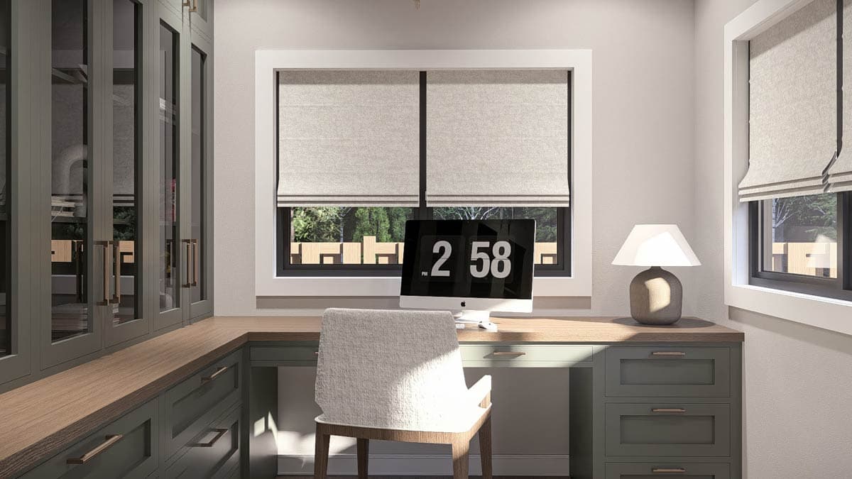 Home office with U-shaped desk, built-in cabinets with glass doors, and dual windows with Roman shades.