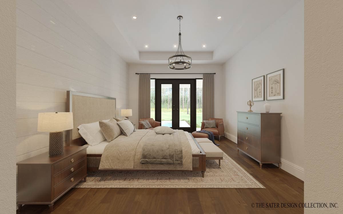 Primary bedroom with a tray ceiling, king bed, double doors to yard, and wood flooring.