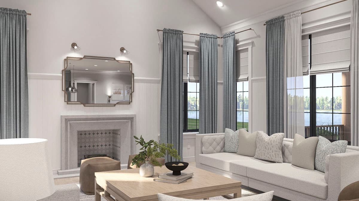 Living room with fireplace, large windows, and sectional sofa.