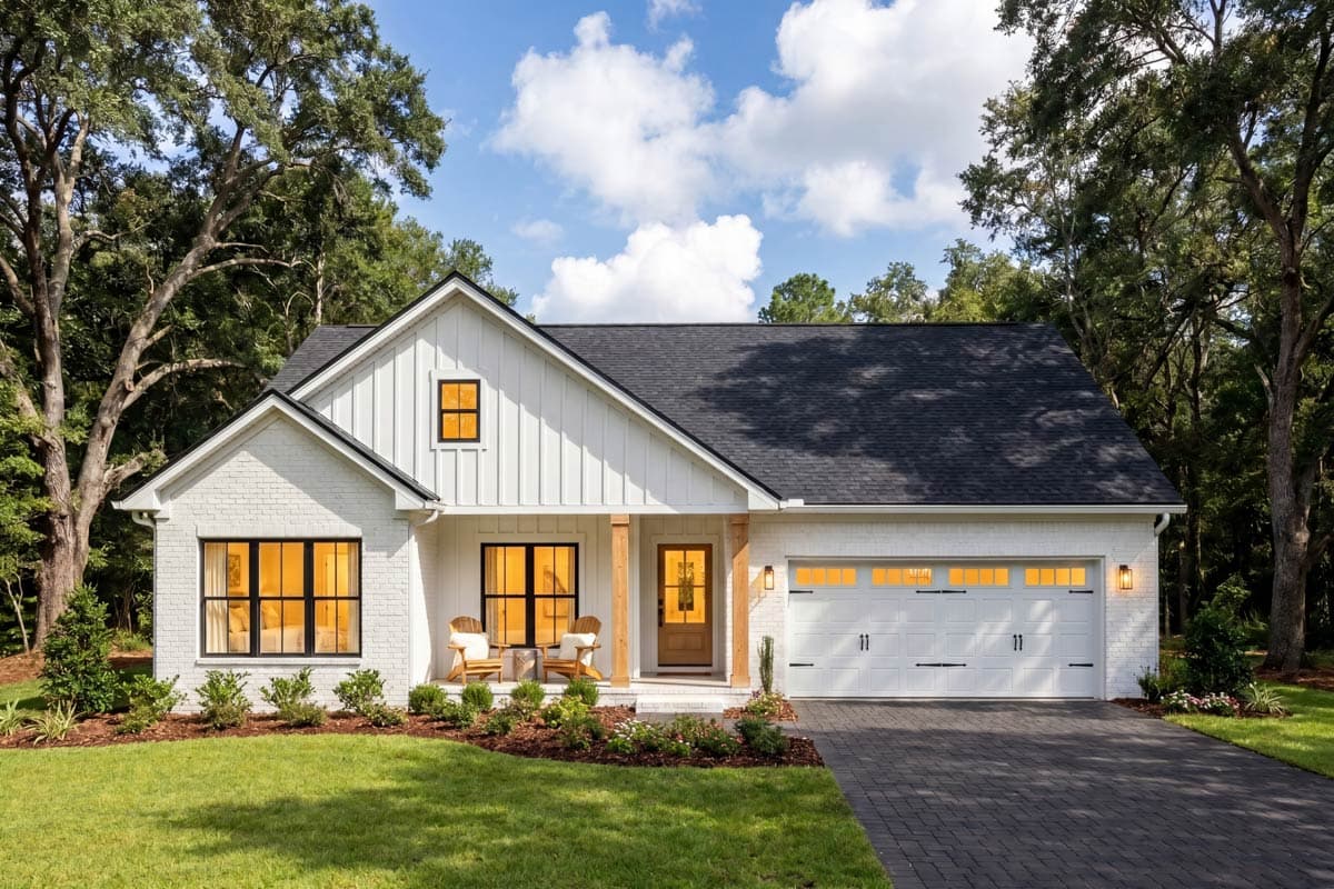 Modern Farmhouse exterior with white brick, board and batten siding, gable dormer, covered porch, and attached garage.