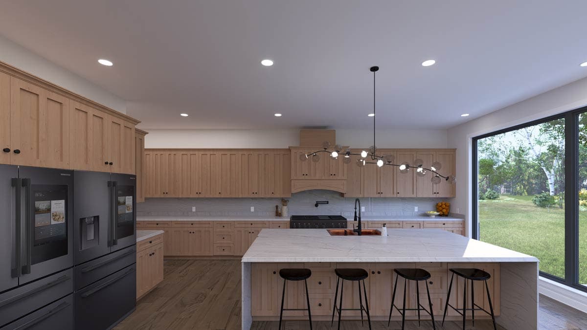 Kitchen with light wood cabinetry, island with seating, dark range hood, and large window overlooking a yard.
