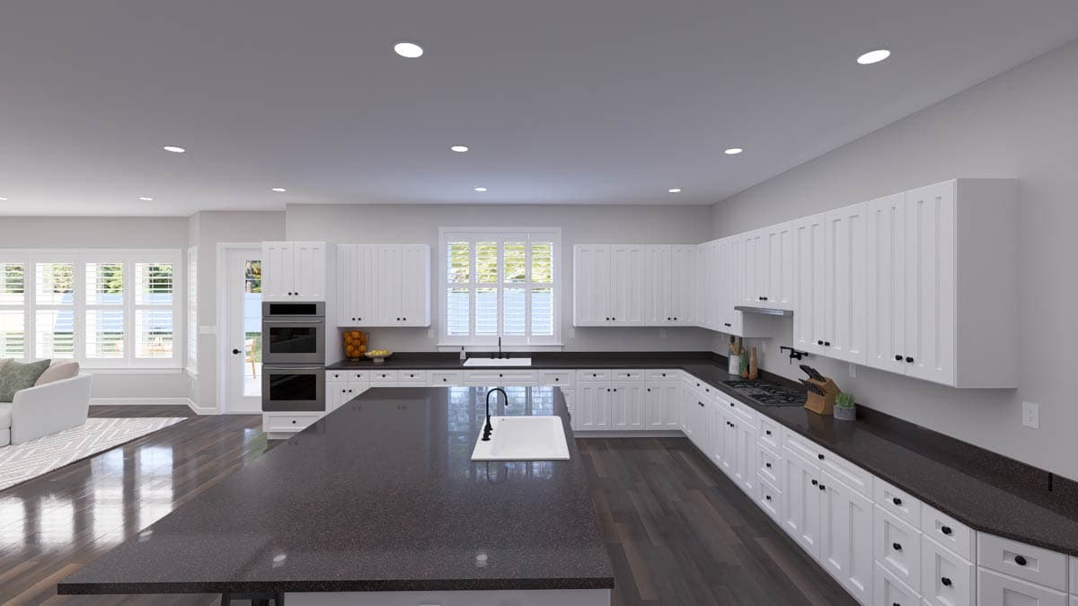Kitchen with white shaker cabinets, dark granite countertops, large island with sink, dual ovens, and gas range.