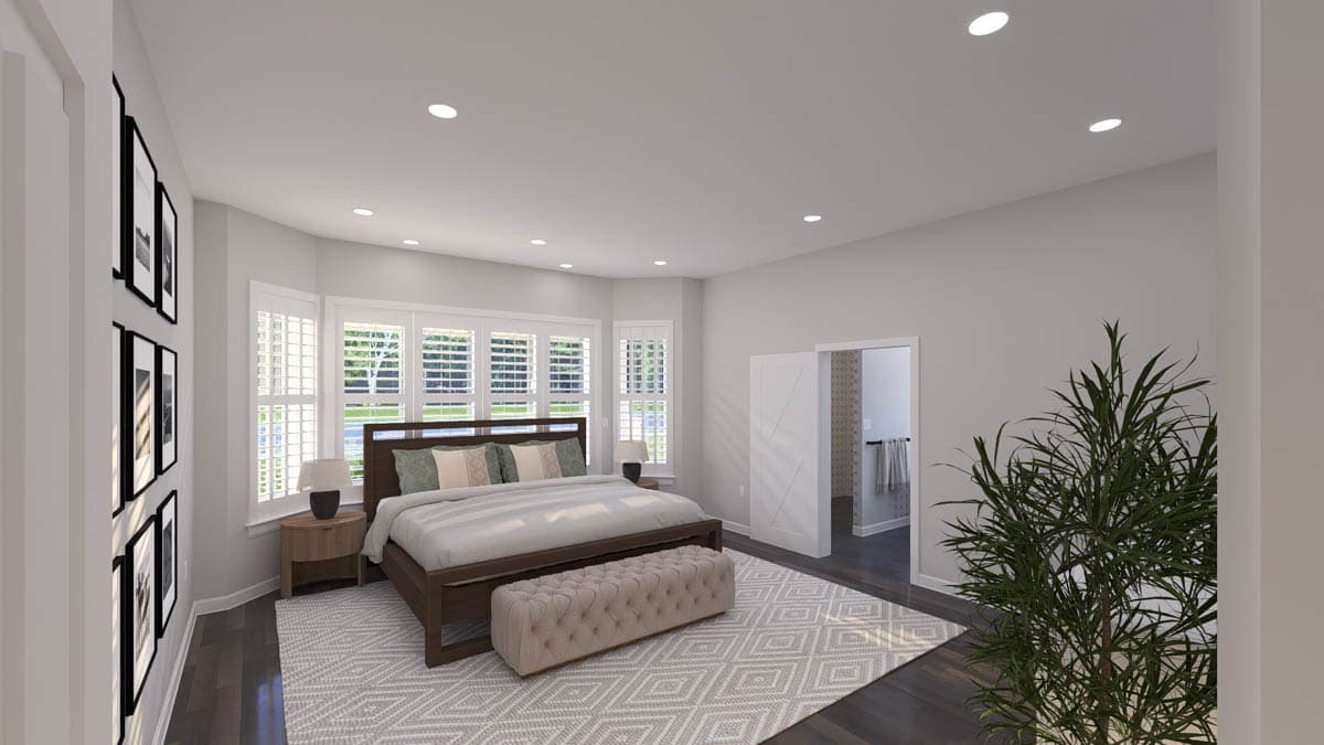 Primary bedroom with bay windows, paneled door to ensuite, and decorative rug.