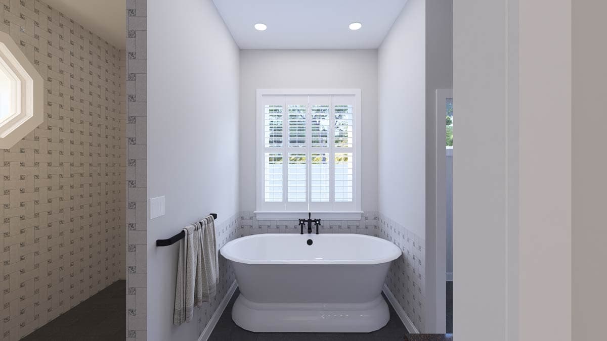 Bathroom with freestanding soaking tub, octagonal window, tiled shower walls, and plantation shutters over a double window.