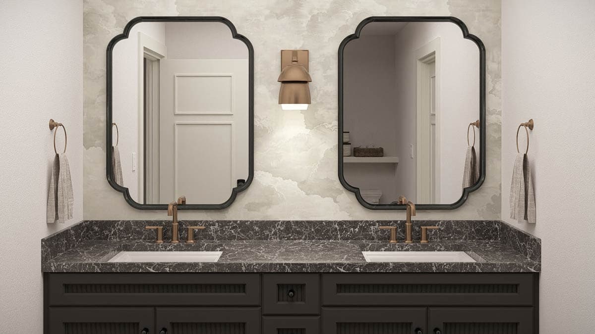 Bathroom vanity with double sinks, dark cabinets, marble countertop, ornate mirrors, and wall sconce.