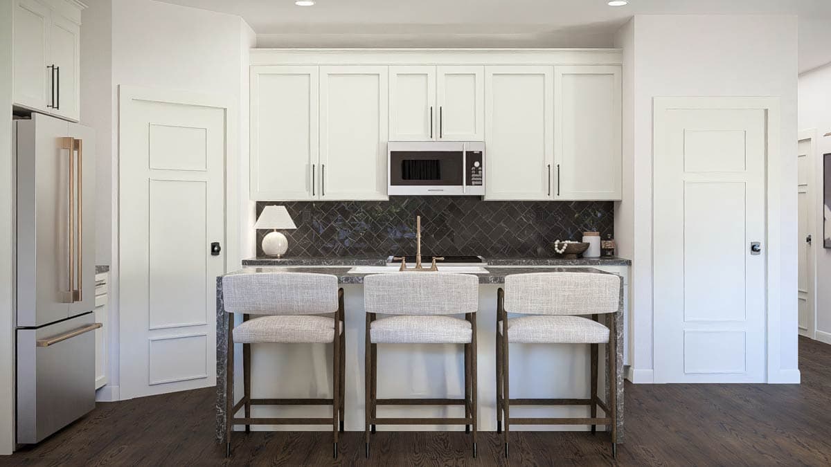 Kitchen with white cabinets, island with seating, stainless steel refrigerator, and dark tile backsplash.