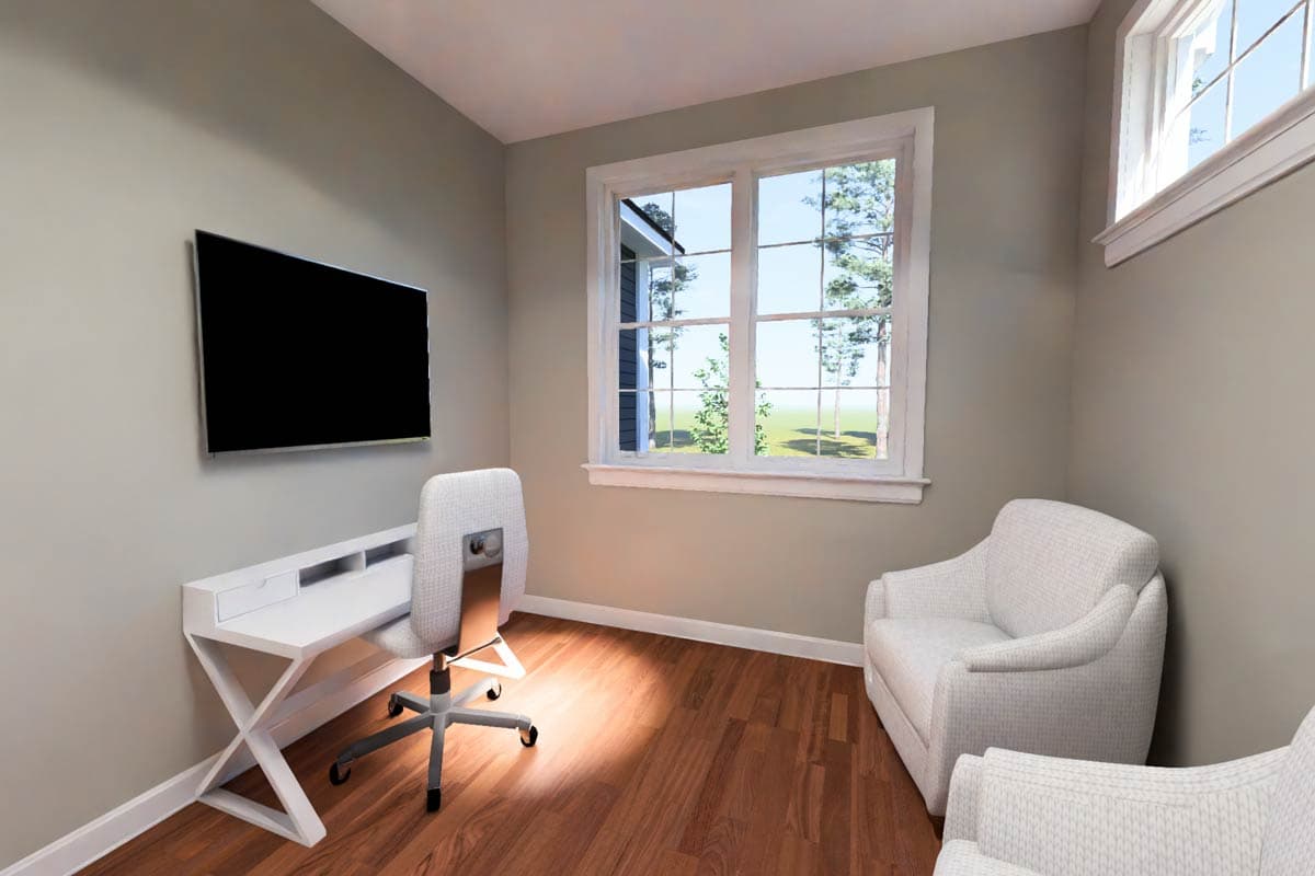 Interior view of a study with a desk, chair, two armchairs, and a large window overlooking trees.