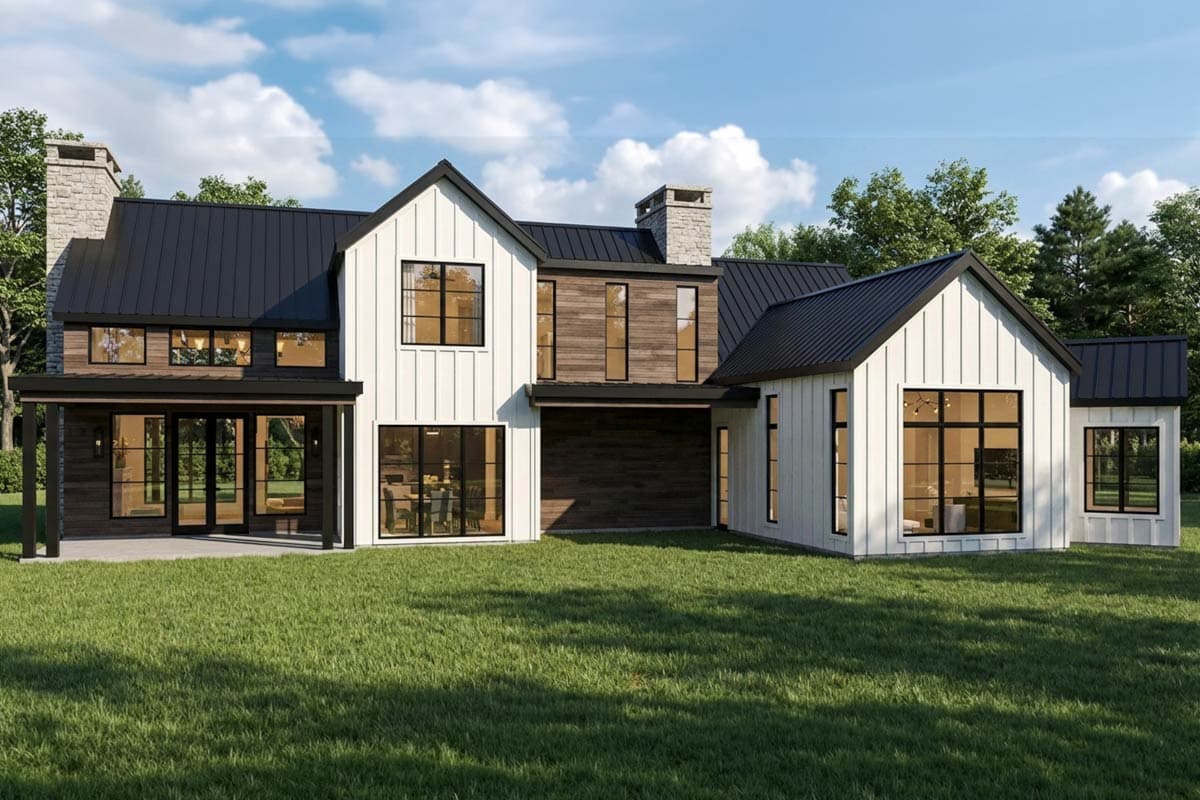 Modern Farmhouse house plan exterior with white board and batten siding, black metal roof, stone chimney, and large windows.