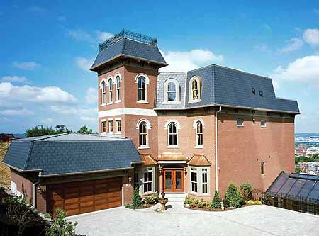 Victorian house plan exterior with brick facade, mansard roof, arched windows, prominent tower, and attached garage.