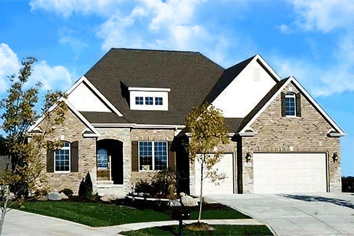 House plan exterior: Two-story home with brick facade, gabled dormer, arched entry, and attached two-car garage.