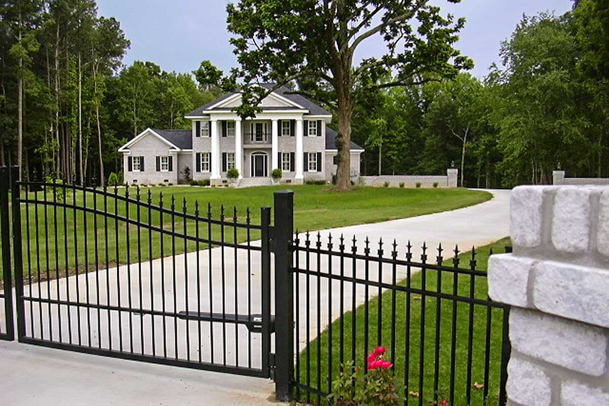House plan exterior: Two-story Neoclassical style home with a portico, columns, and brick facade.