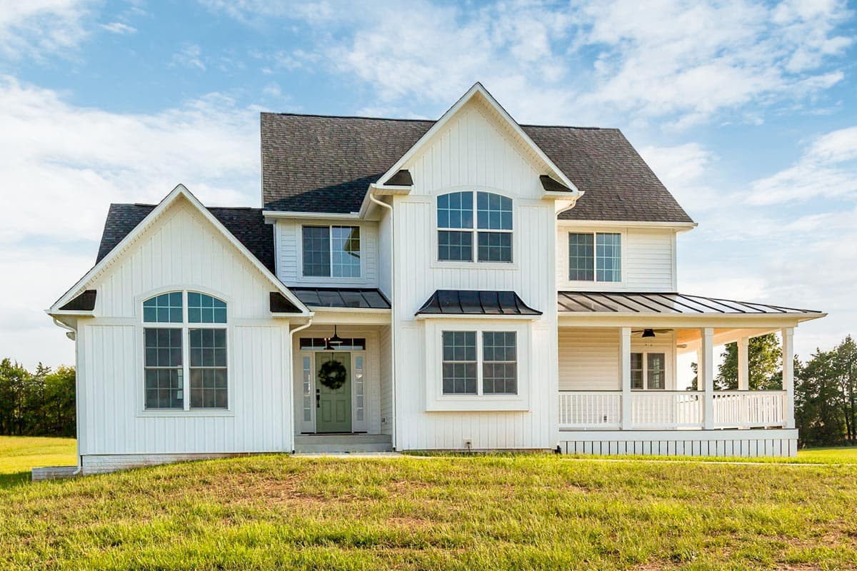 House plan exterior. Two-story Modern Farmhouse with gables, a covered porch, and a combination of vertical and horizontal siding.