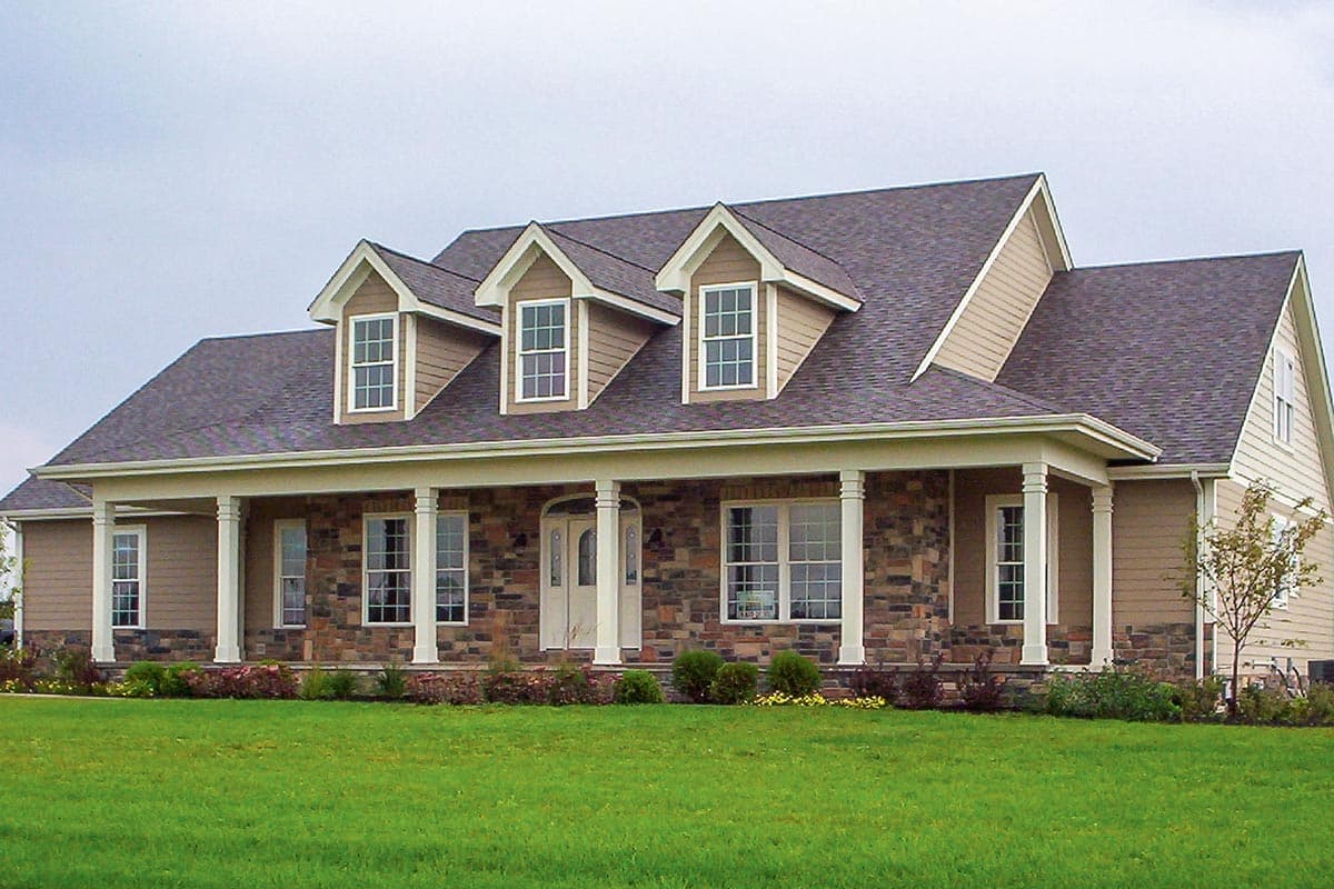 House plan exterior: Ranch style, one story, full front porch with columns, stone skirt, and three gabled dormers.