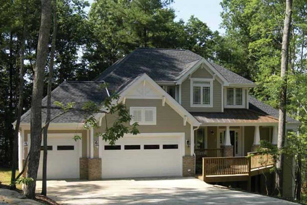 House plan exterior: Two-story home with a three-car garage, covered front porch, and a deck.