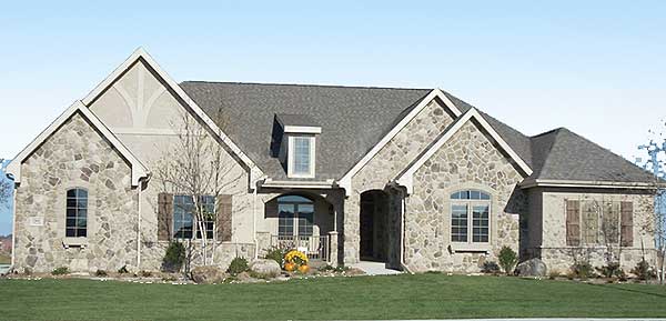 House plan exterior featuring stone facade, arched windows, dormer, and prominent gables.