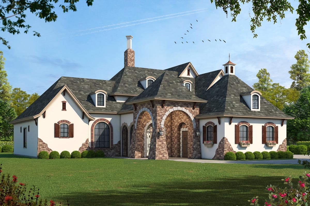 House plan exterior. Two-story French Country home with multiple gables, arched entry, dormers, and stone accents.