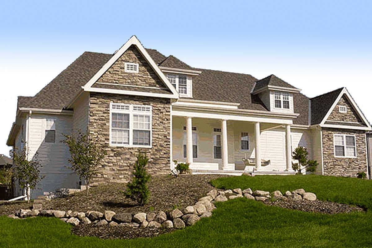 House plan exterior: Two-story home with stone accents, front porch with columns, and dormer windows.